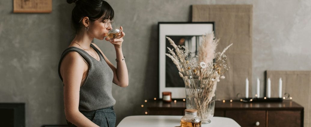 Woman enjoying tea at home as part of a calm health after 40 routine