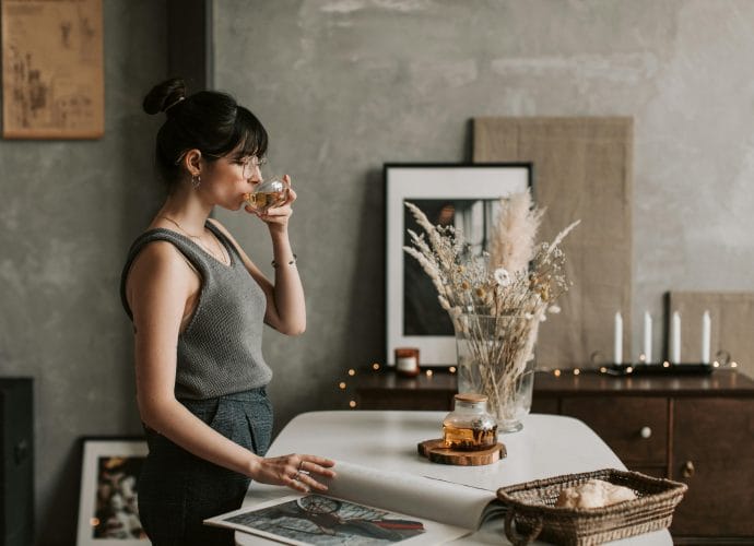 Woman enjoying tea at home as part of a calm health after 40 routine