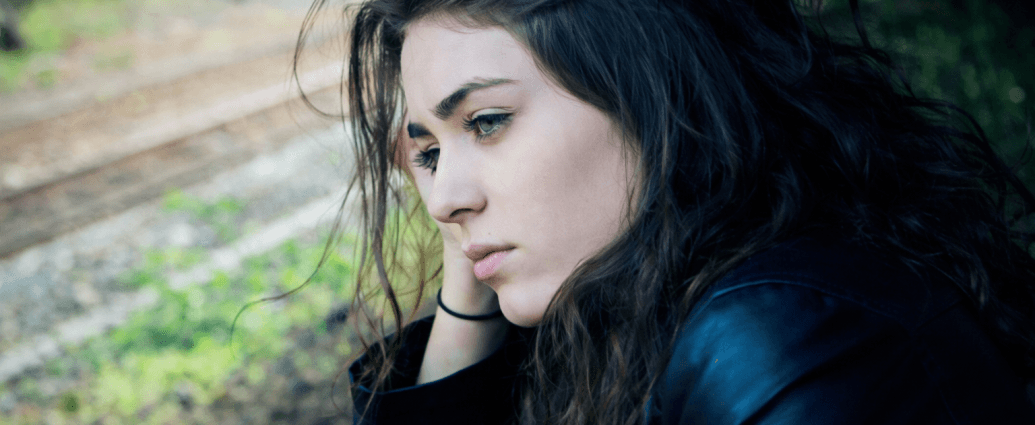 Thoughtful woman looking away outdoors, reflecting on her career path and considering a change