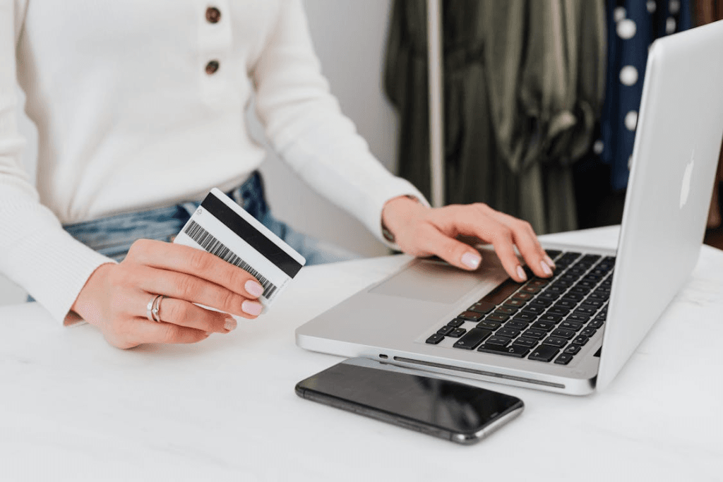 Woman making a structured credit card payment on her laptop as part of a debt repayment plan