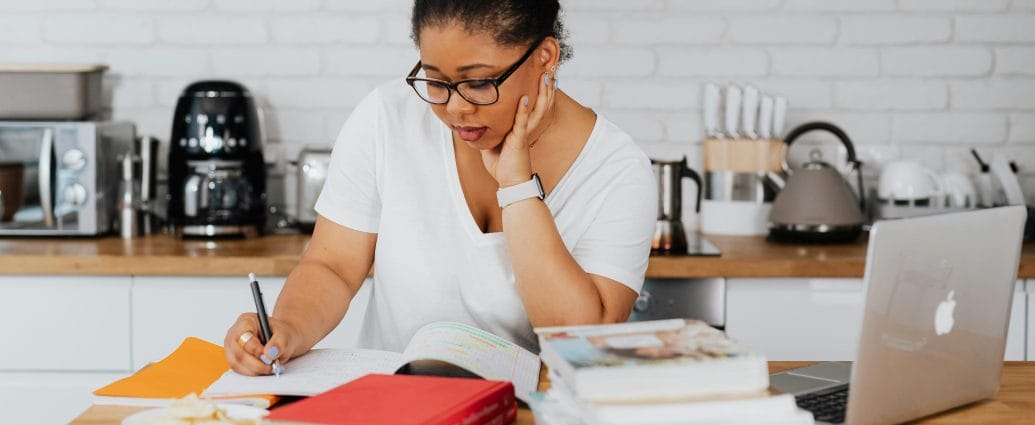 Healthy lifestyle vision after 40 with a woman writing in a notebook at home