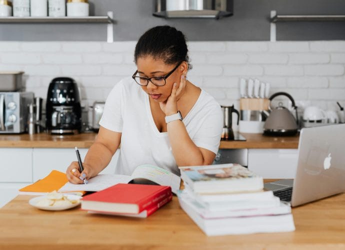 Healthy lifestyle vision after 40 with a woman writing in a notebook at home