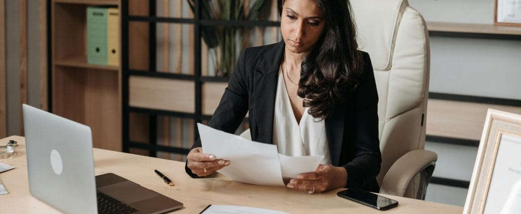 Woman preparing documents before asking for a raise at work