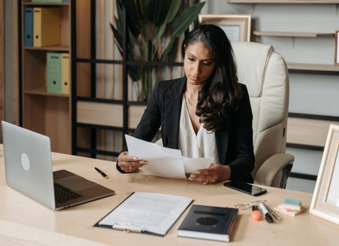 Woman preparing documents before asking for a raise at work