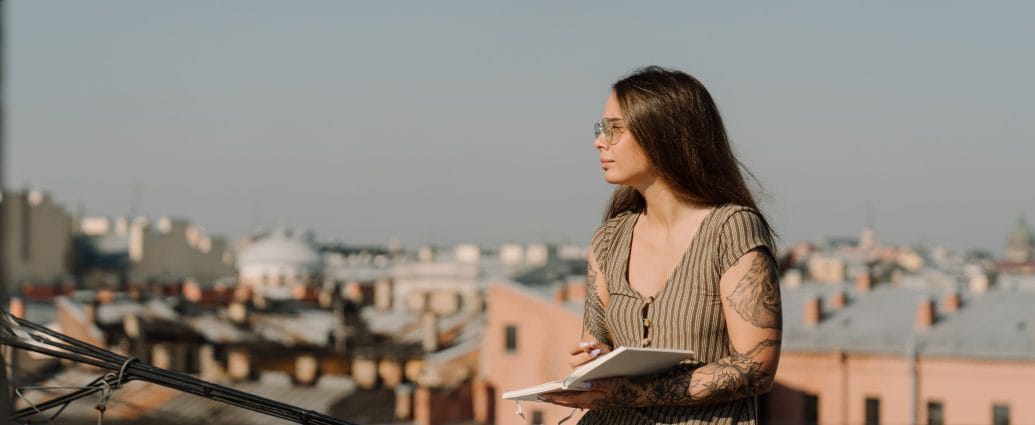 Woman writing in a journal while visualizing the healthy relationships she wants in her life.
