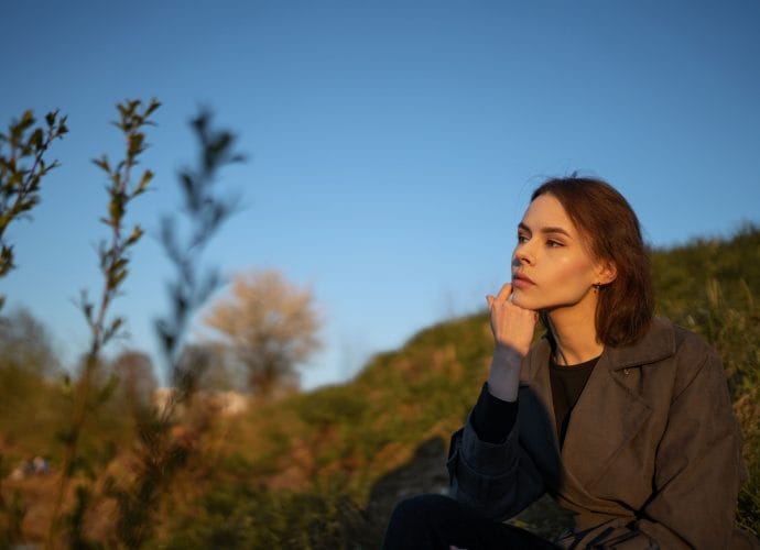 Woman reflecting on how to analyze her hobbies and free time using the AVM Method