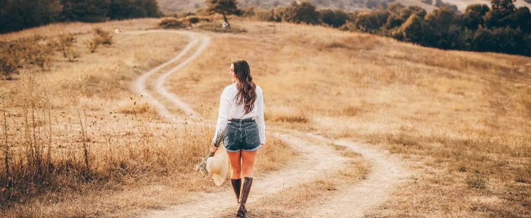 Woman on a winding path reflecting on the four truths of life