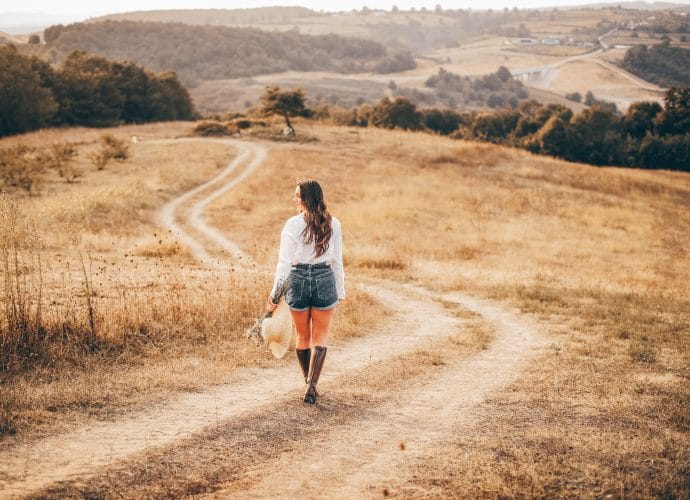 Woman on a winding path reflecting on the four truths of life