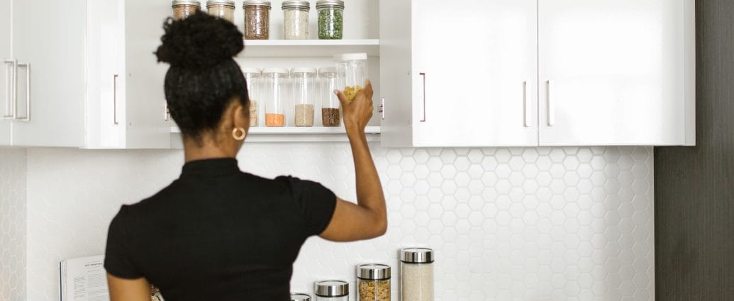 Woman organizing her home one room at a time using practical storage systems