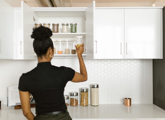 Woman organizing her home one room at a time using practical storage systems